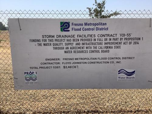Fancher Detention Basin construction sign recognizing the funding provided by the state of california Prop 1Water Bond of 2014 and all other project proponents.
