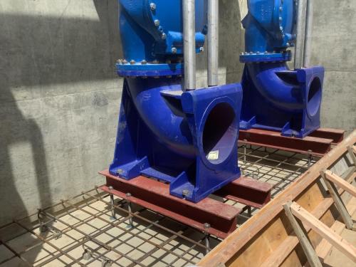 KSB brand epoxy coated cast iron pump discharge elbow mounted in the Fancher Basin Pump Intake Structure on top of I-Beams ready to be permanently set into concrete.