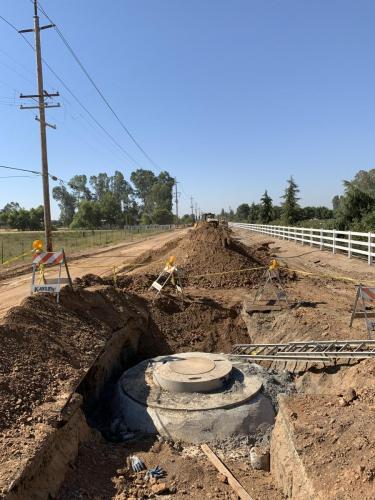 Open storm drain trench with unfinished manhole in McCall Avenue north of McKinley Avenue