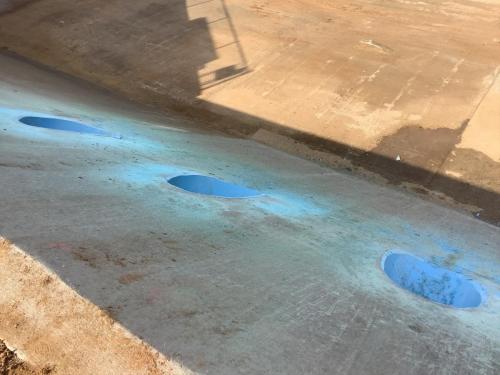 30" C-900 blue pipe penetrations in Fresno Canal. Pipes are cut flush with the canal embankment