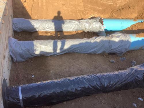 3 Ductile Iron Pump Station discharge pipes in parallel wrapped in visquene